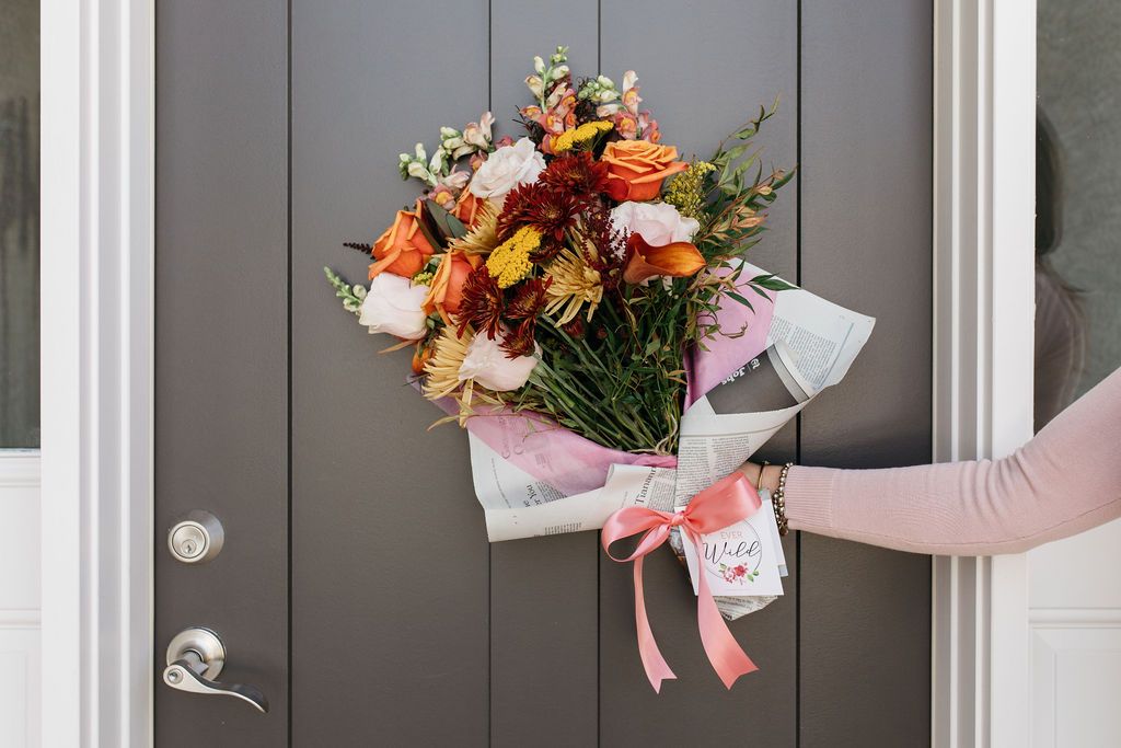 Best Kansas City floral delivery near me, woman holding autumn flowers