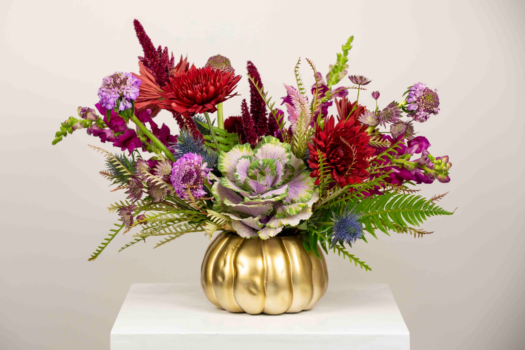 Kansas City Flower Delivery. Fall flowers in pumpkin vase with kale, cremons, amaranthus, snapdragons and blue thistle. Same day flower delivery for centerpieces and Thanksgiving flowers.