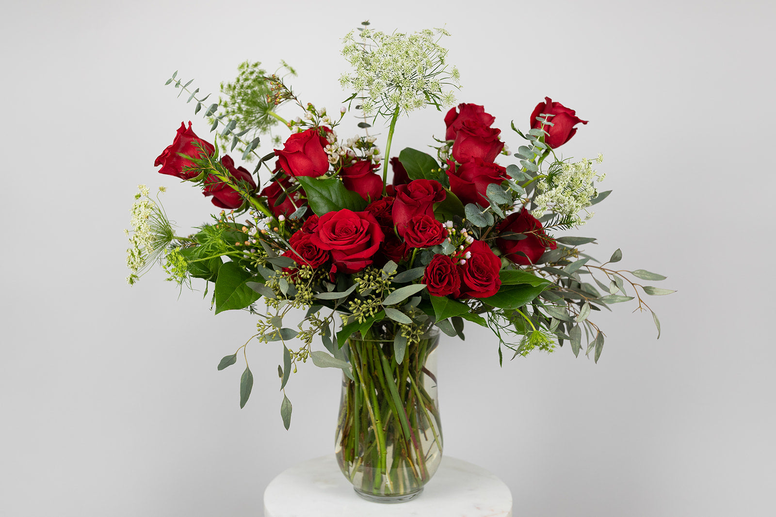 The lover is filled with extra-large red roses, red spray roses, queen anne's lace, and romantic eucalyptus greenery. Valentien's flower delivery available for same day delivery in the local Kansas City great metro area. Red rose arrangement for Valentine's Day. 